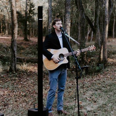Reagan performing for an outdoor wedding ceremony