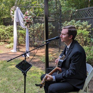 Reagan performing at a garden wedding ceremony