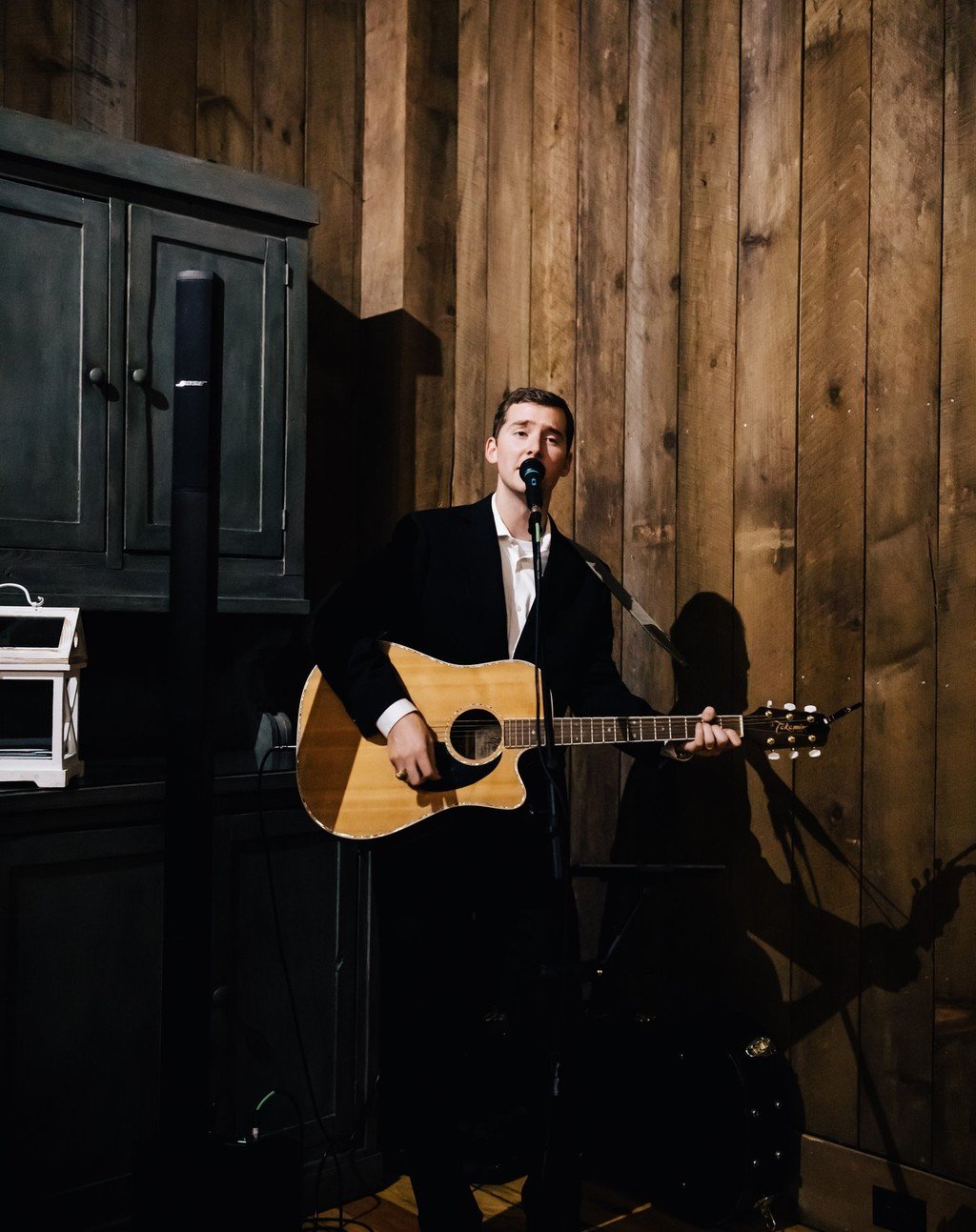 Reagan performing on stage at an indoor venue