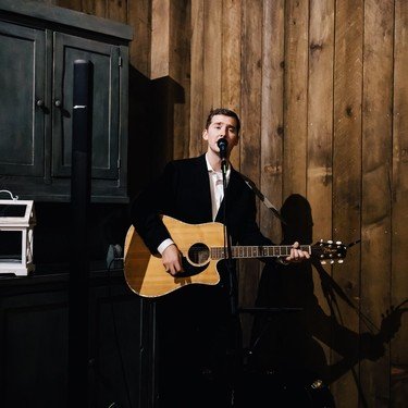 Reagan performing on stage at an indoor venue